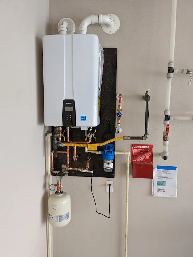 Professional plumber installing copper piping in a Crestline home